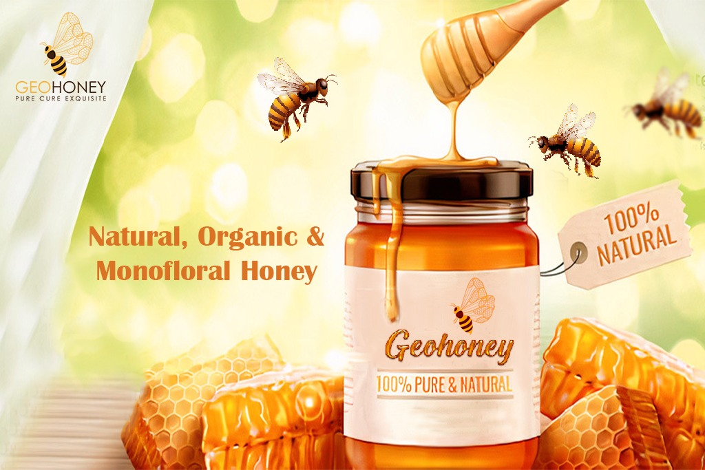 A jar of honey with a wooden spoon on a blurred background with honeycomb cells visible.